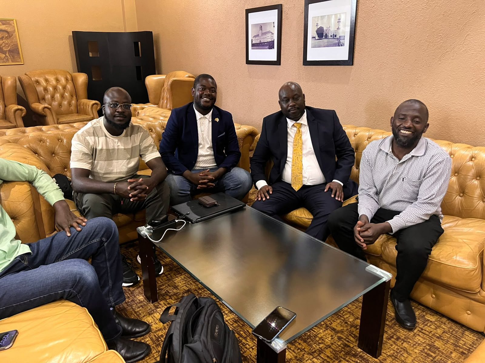A group seated together for a meeting in a hotel lounge
