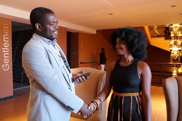 Two people shaking hands and smiling at a networking event