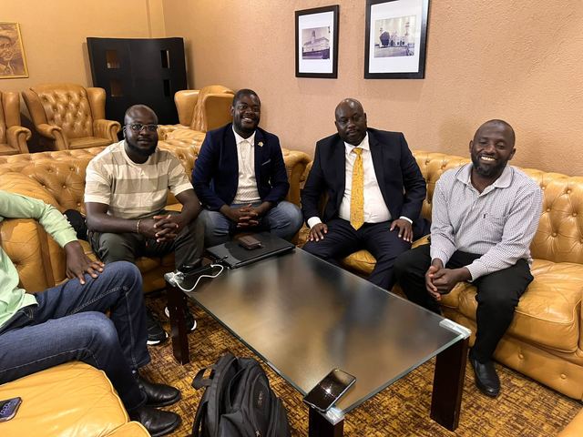 A group seated together for a meeting in a hotel lounge