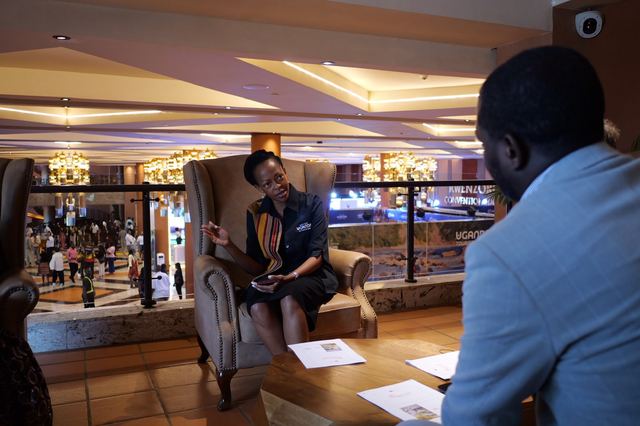 A Uganda tourism representative in conversation at a convention centre
